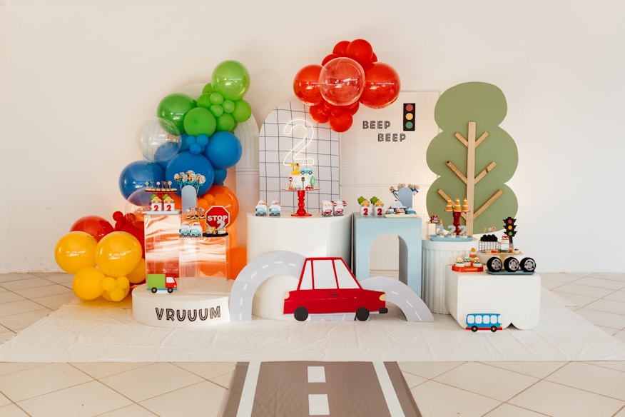 Mesa de doces de festa infantil com decoração tema carros e balões coloridos